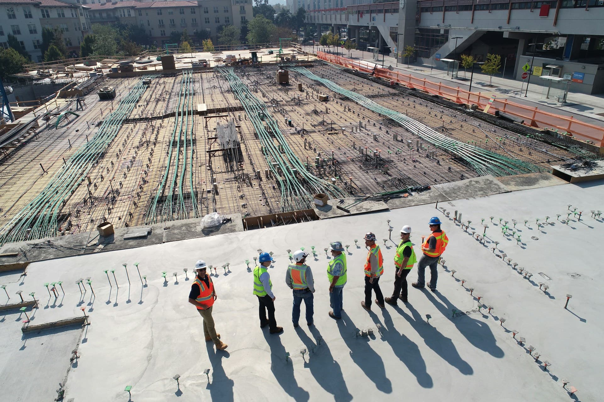General contractor and field team reviewing slab MEP and conduit layout before pour
